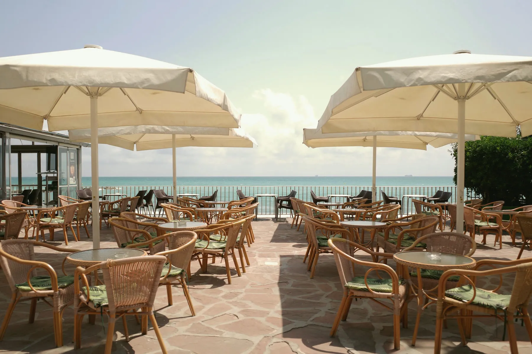 Deniz kenarında şemsiyeli restoran terası
